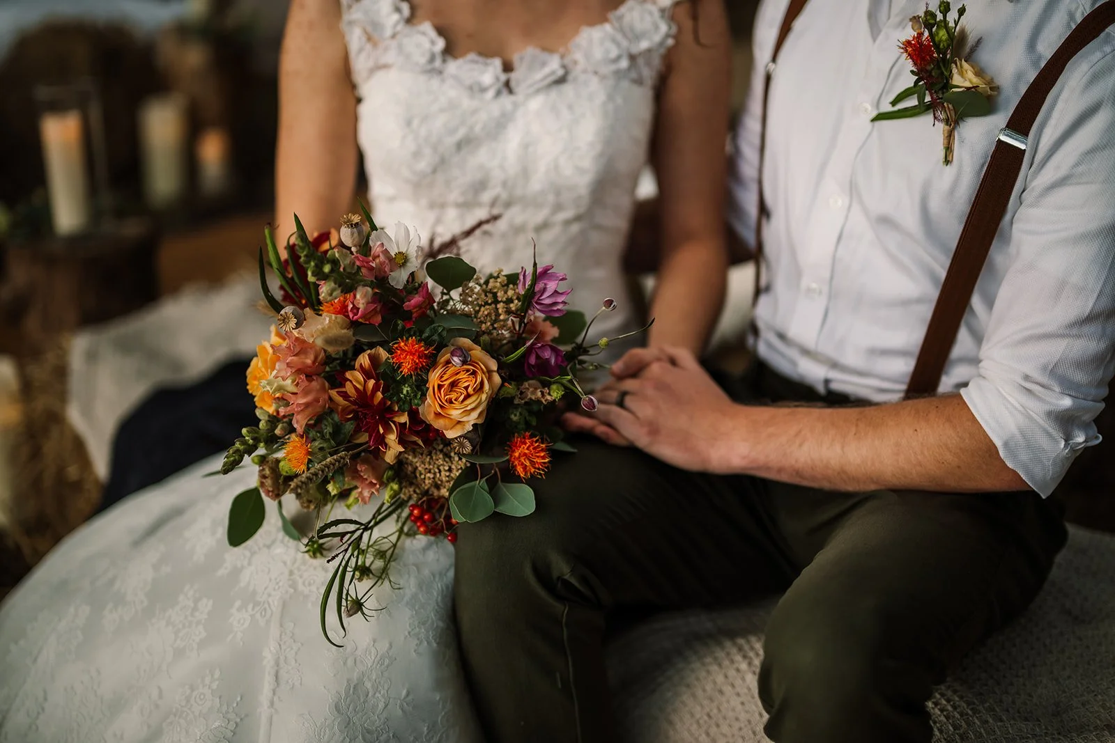 A close-up of a couple holding a vibrant, seasonal wedding bouquet, highlighting natural florals and sustainable styling by Wild Soul Weddings, eco wedding planners in the UK. Rach Elizabeth Photography.