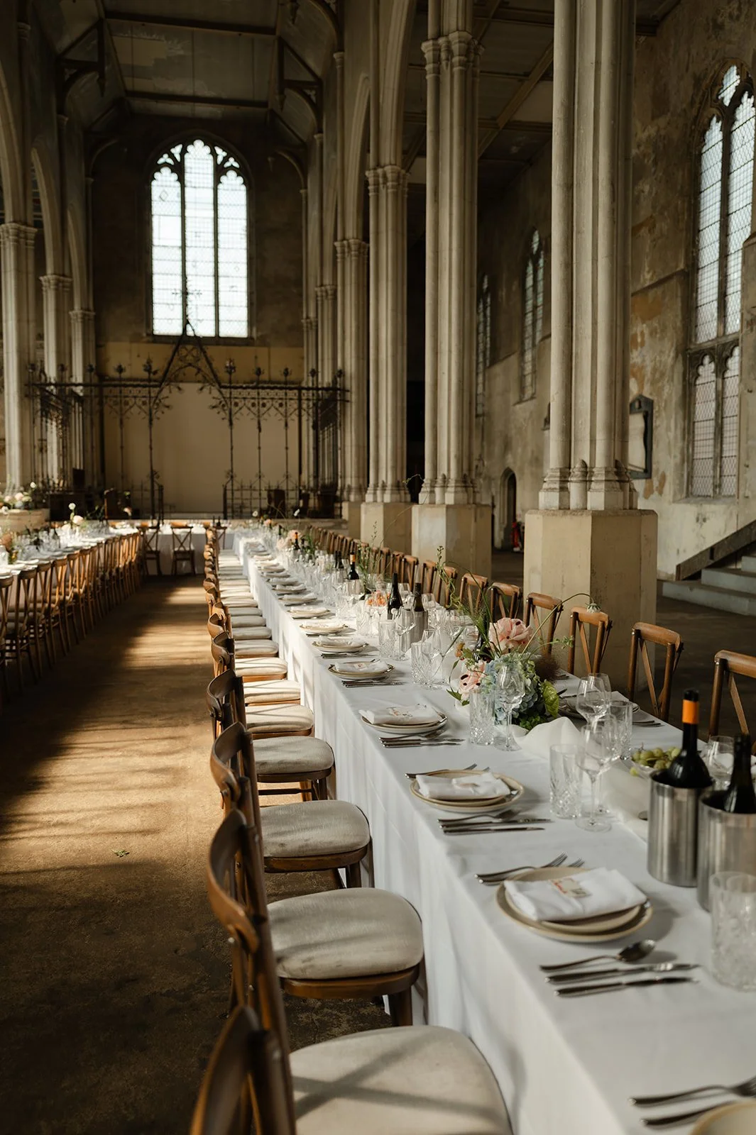 A long table, set and prepared for a wedding dinner. Chloe Mary - London Wedding Photographer. 