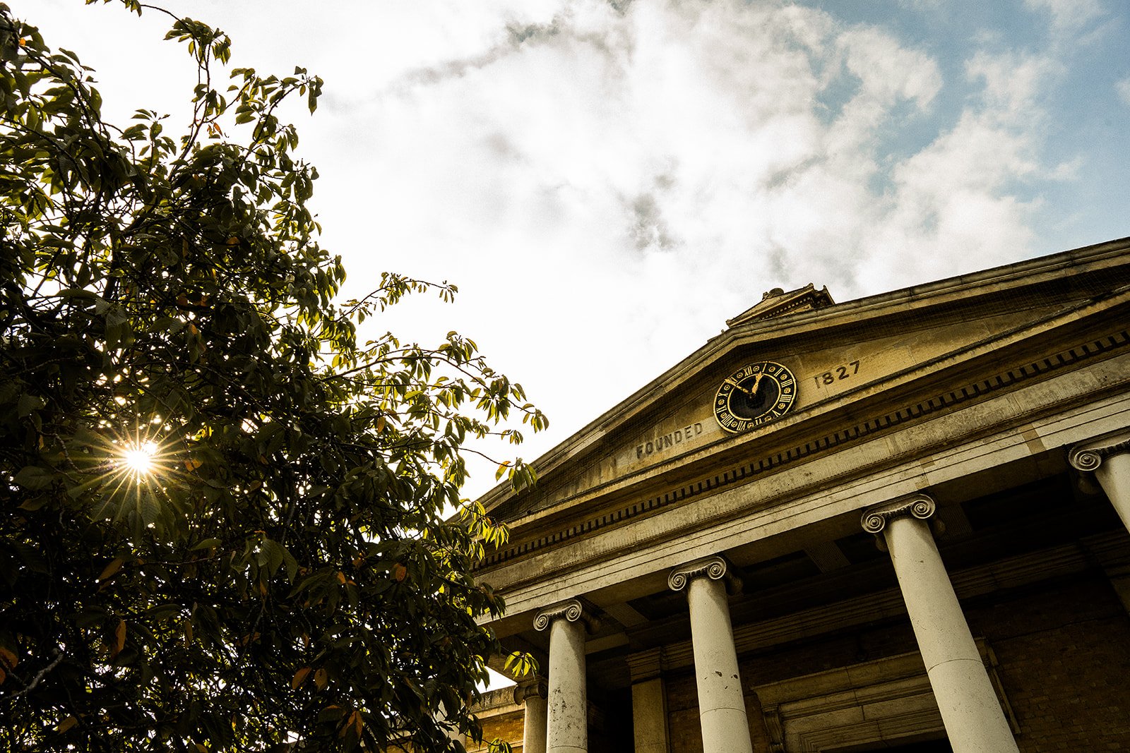 The outside of the Asylum Chapel with the sun shining through the trees.
