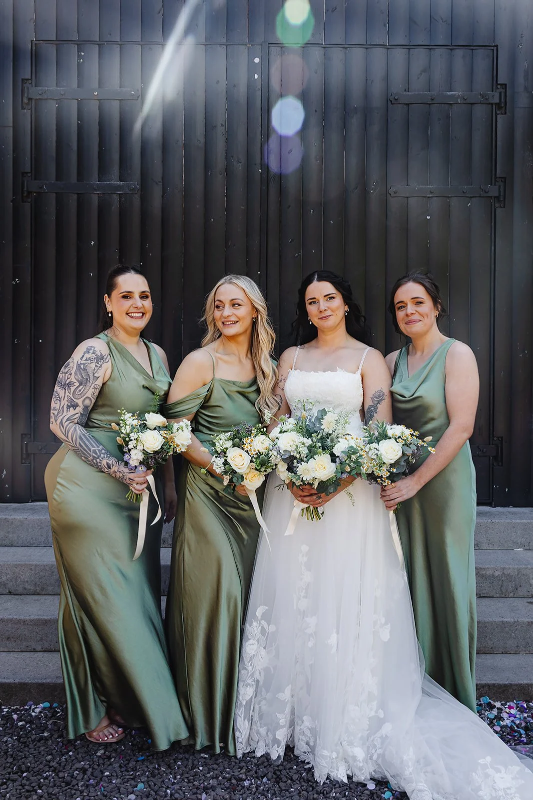 Marie with her bridesmaids, in the sunshine outside of the The Engine Works, Glasgow.