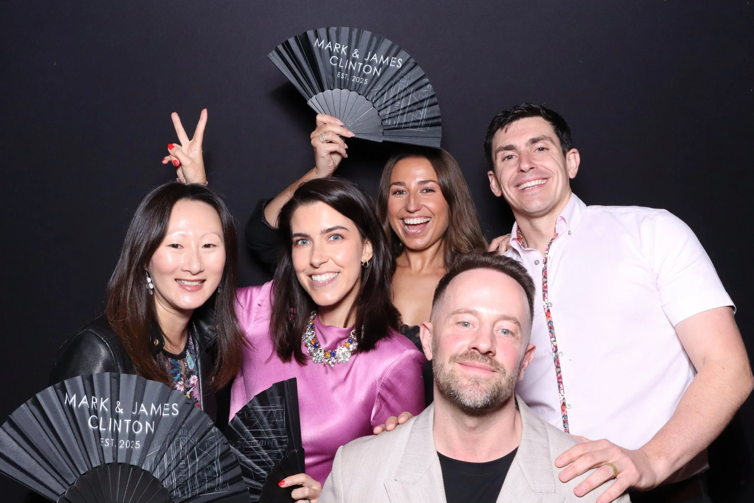 Guests joined Mark and James to celebrate their wedding in chic, modern style with Viva La Booth. The sleek black backdrop and custom fans featuring the couple’s names added a personal, polished touch. Every photo captured the laughter, love, and per