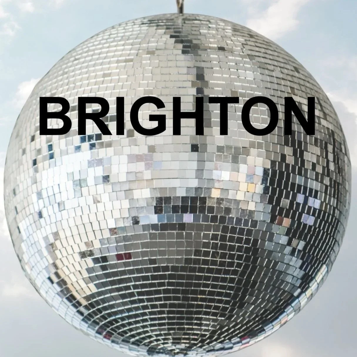 A disco ball on a cloudy sky background