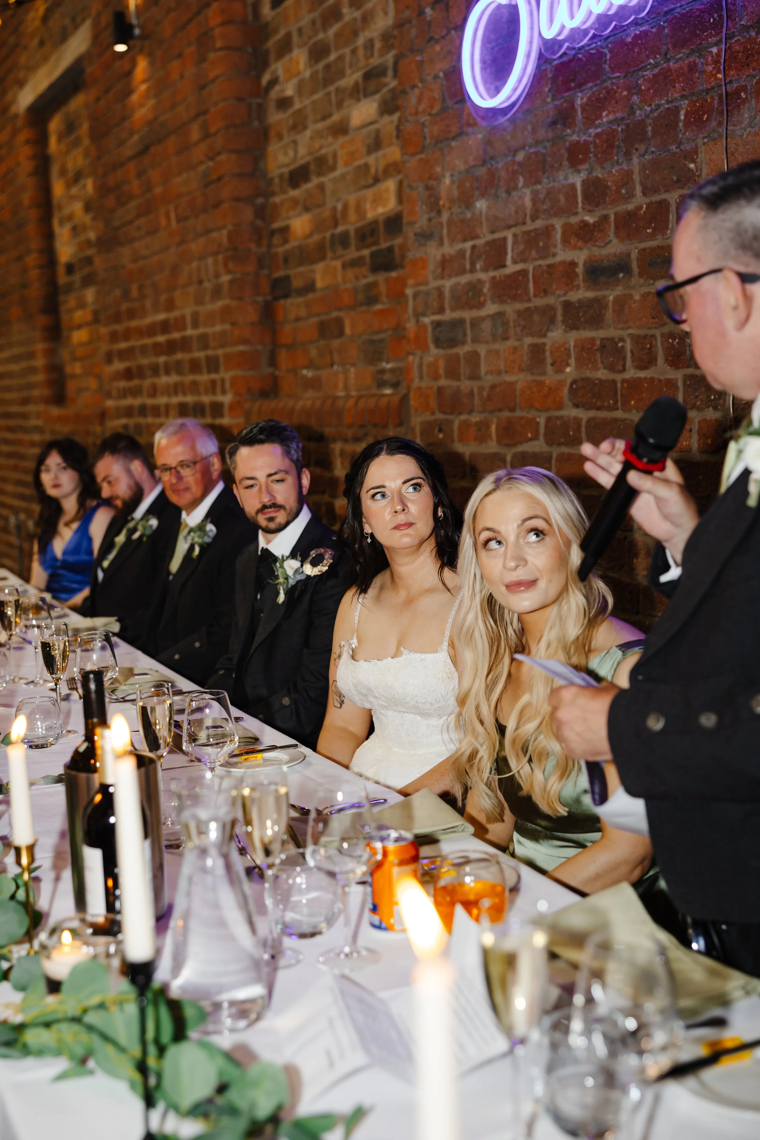Oliver, Marie, and the guests at the top table look on as the speeches are delivered.