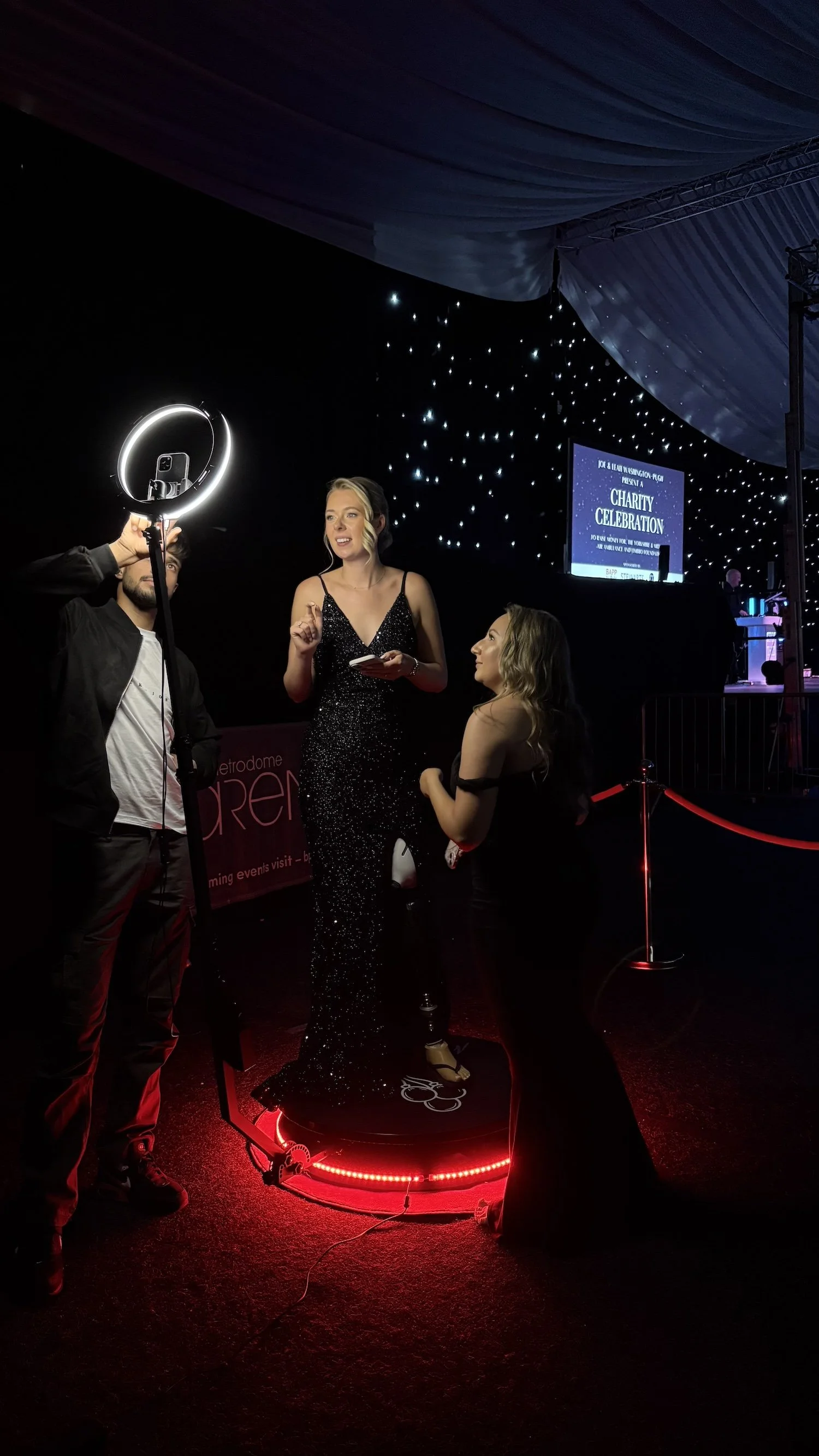 Guests at a wedding having fun in front of Mark the Event's Selfie Pod.