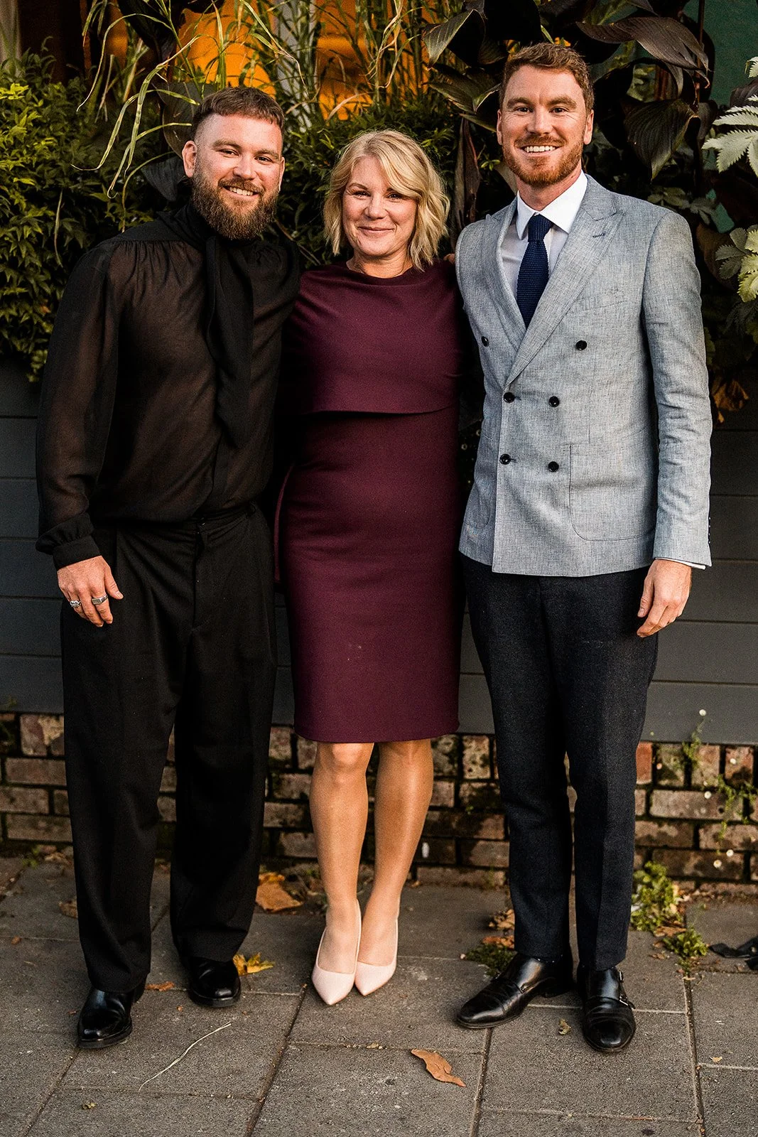 A groom with his mum and his brother on his wedding day.