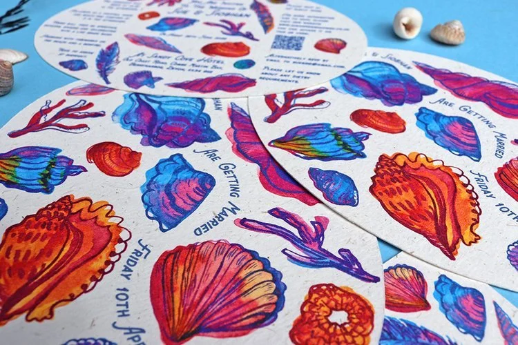 Vibrant seaside-inspired wedding invitations by Different Day Design Studio, Dorset. Featuring colourful hand-illustrated seashells and coral designs, this bold stationery set captures a fun coastal wedding theme - perfect for beach-loving couples pl