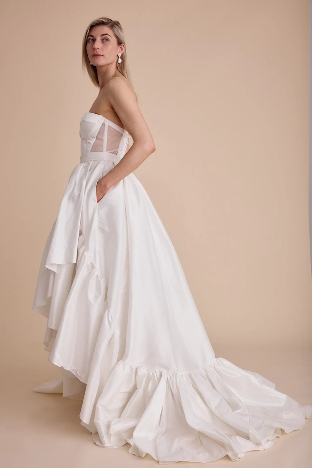 An upcycled wedding gown with pockets. The dress is by Swans Bridal, West Sussex
