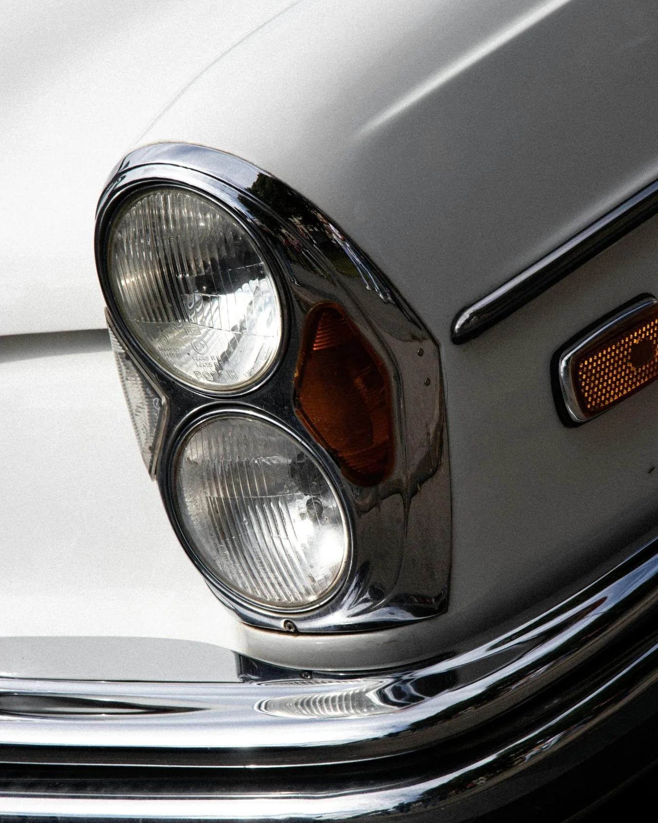 White, vintage wedding car lights and chrome detals.