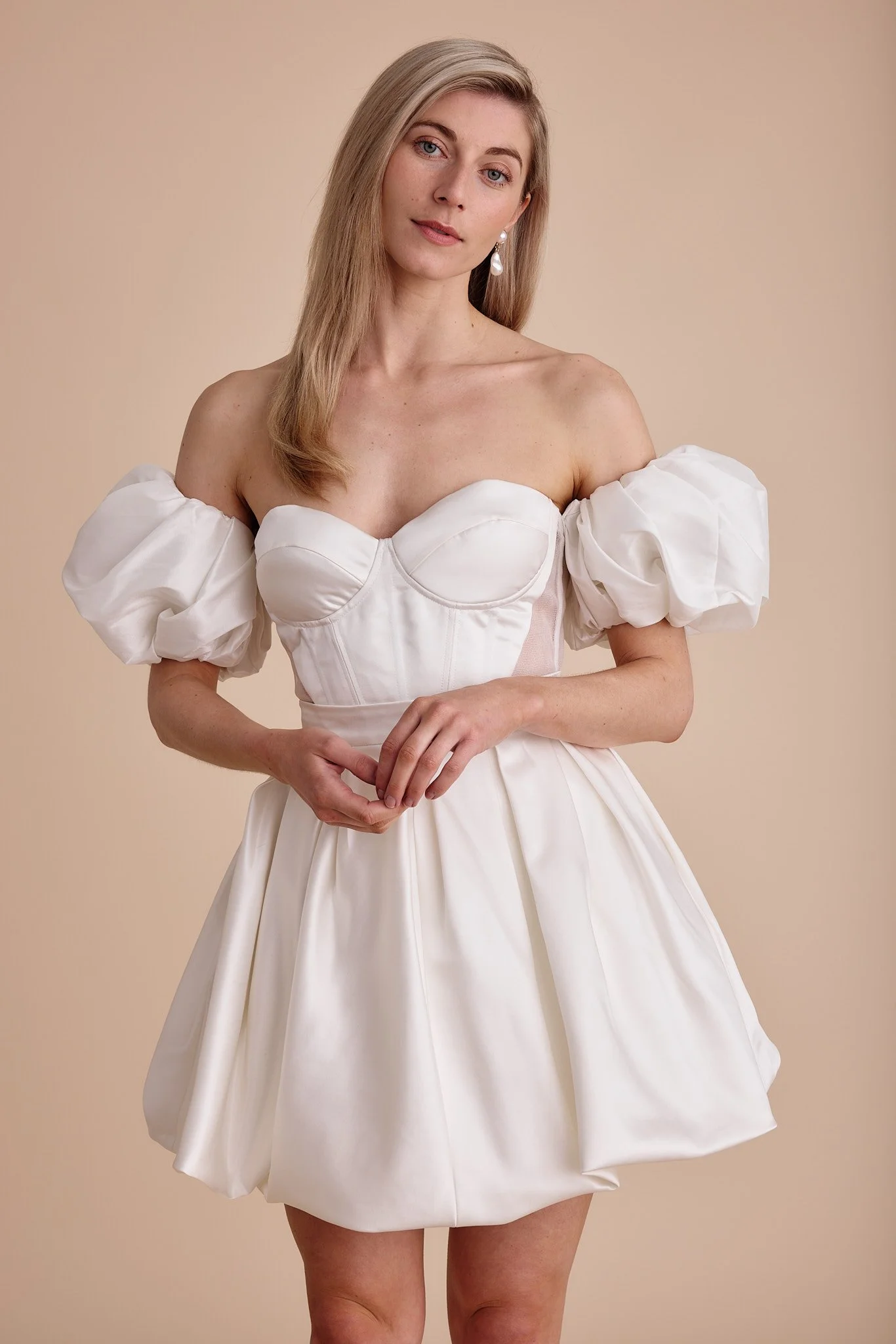 A close up of a cute wedding dress with puff sleeves by Swans Bridal