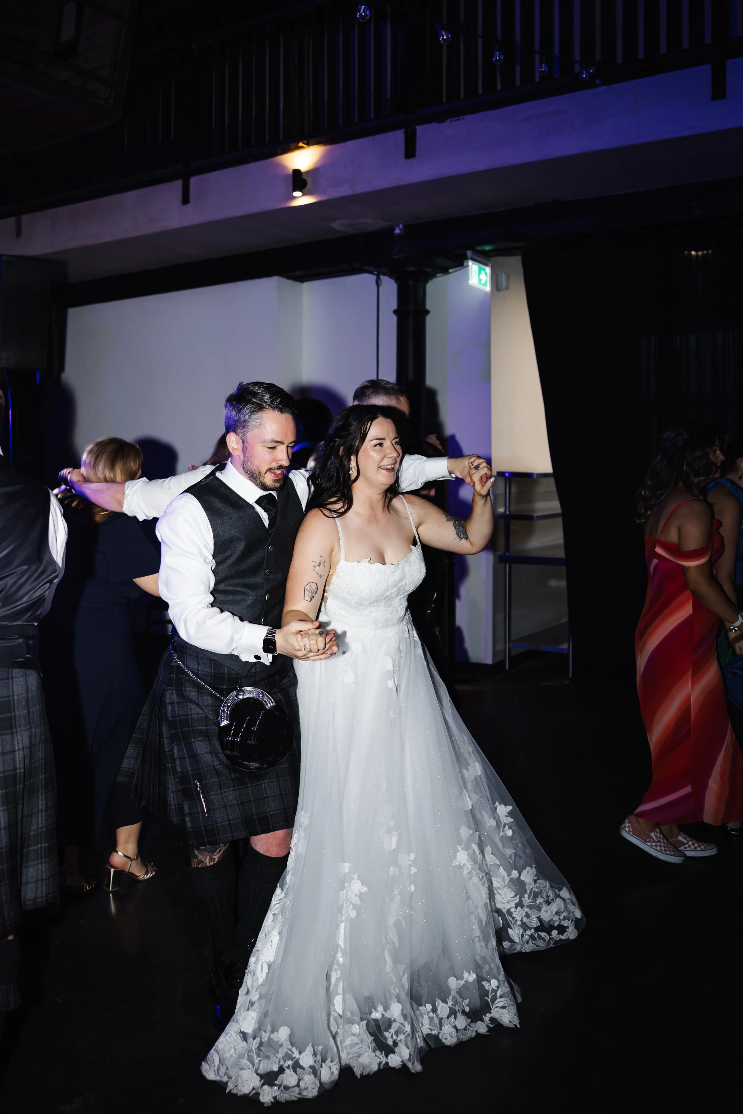 Oliver and Marie having a dance with guests at the wedding.