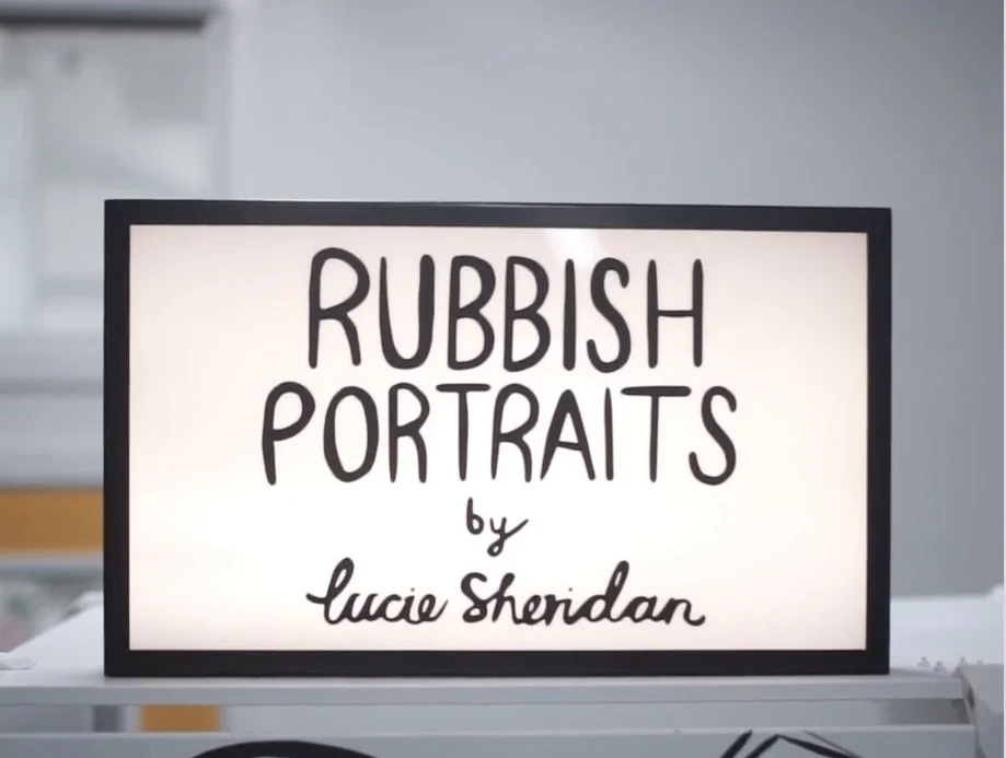 A bright lightbox sign displaying Rubbish Portraits by Lucie Sheridan, the instantly recognisable branding for Lucie’s live illustration booth. Simple, bold and playful, it perfectly captures the creative spirit behind her three minute portrait exper