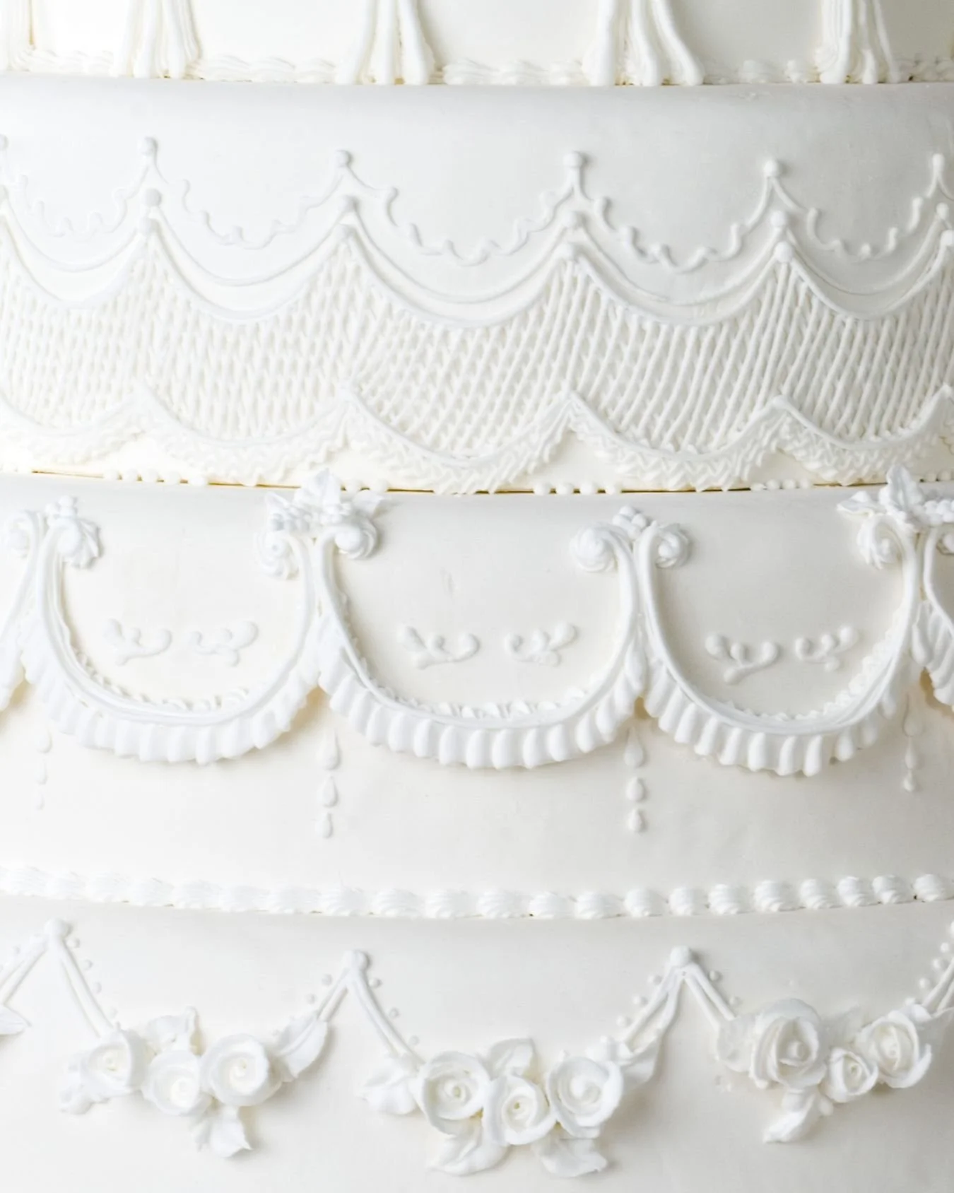 A simple shot of a 3 tiered wedding cake with white icing.