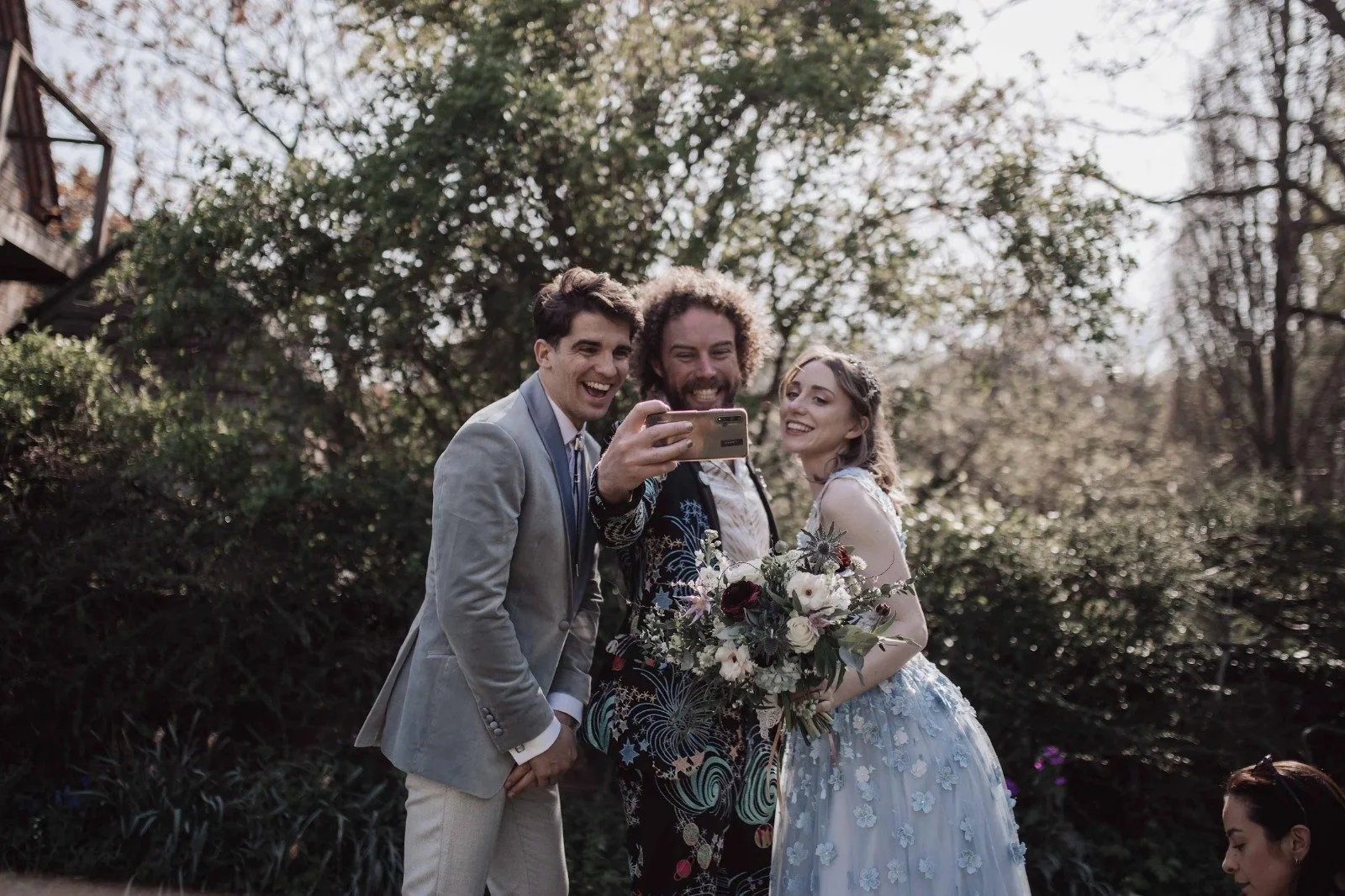 Festival-style wedding ceremony led by celebrant Lonan Jenkins, capturing candid moments, vibrant outfits, live music, heartfelt vows and inclusive, non-traditional celebrations filled with laughter, connection and community.