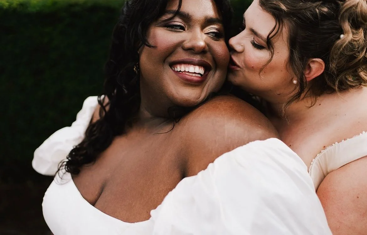 A romantic wedding portrait featuring soft, radiant makeup by Powder Blue Artistry. The glowing skin, natural tones, and subtle highlight enhance each bride’s features beautifully, creating a warm and joyful look perfect for modern UK weddings. Photo
