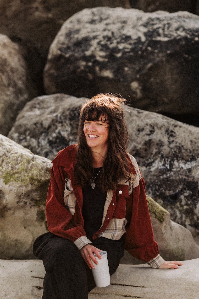 A relaxed portrait of an eco wedding planner enjoying a quiet moment outdoors, reflecting the grounded, nature-led ethos behind Wild Soul Weddings, eco wedding planners in the UK. Dominic Williams Photography