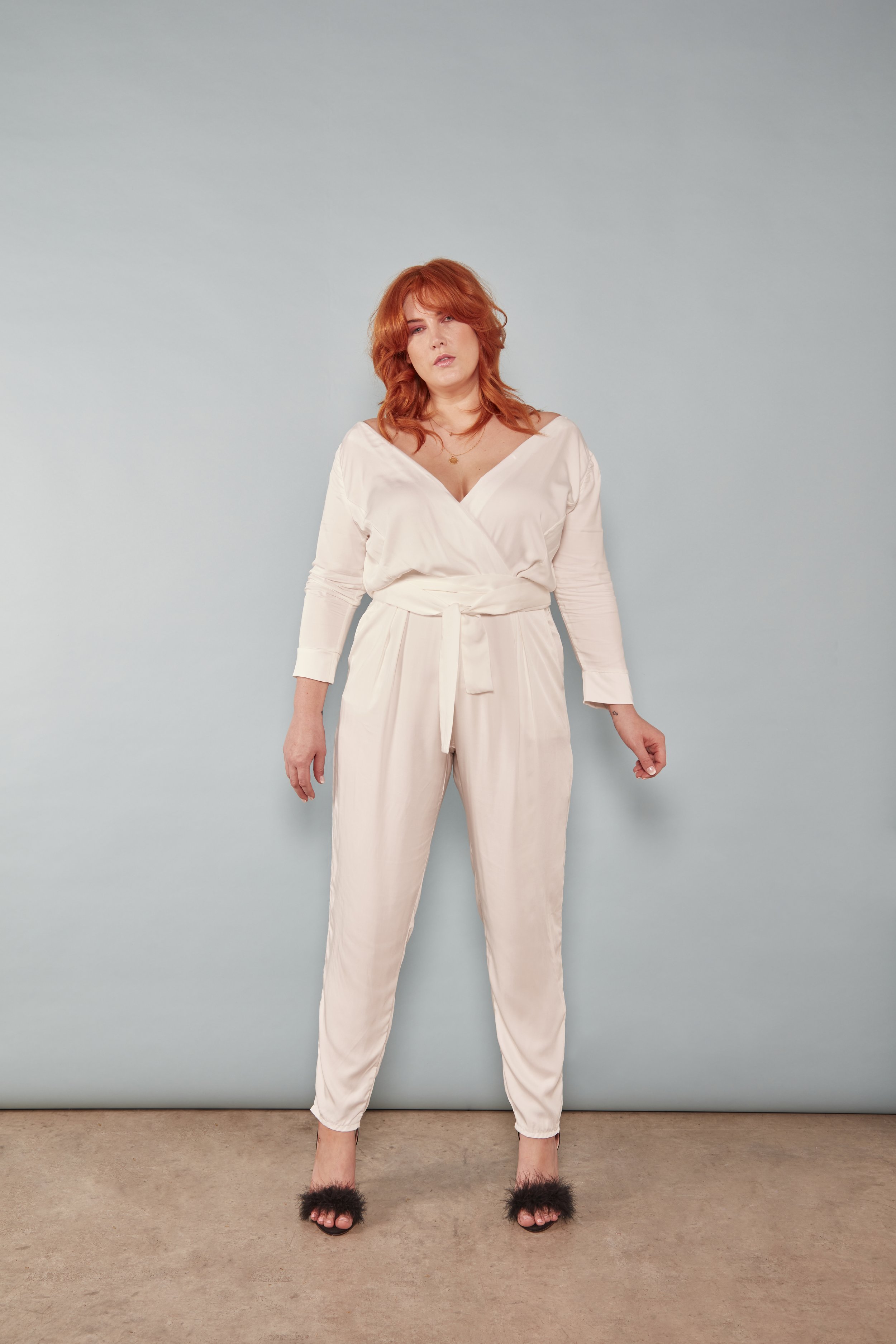 A red haired bride wearing a jumpsuit.