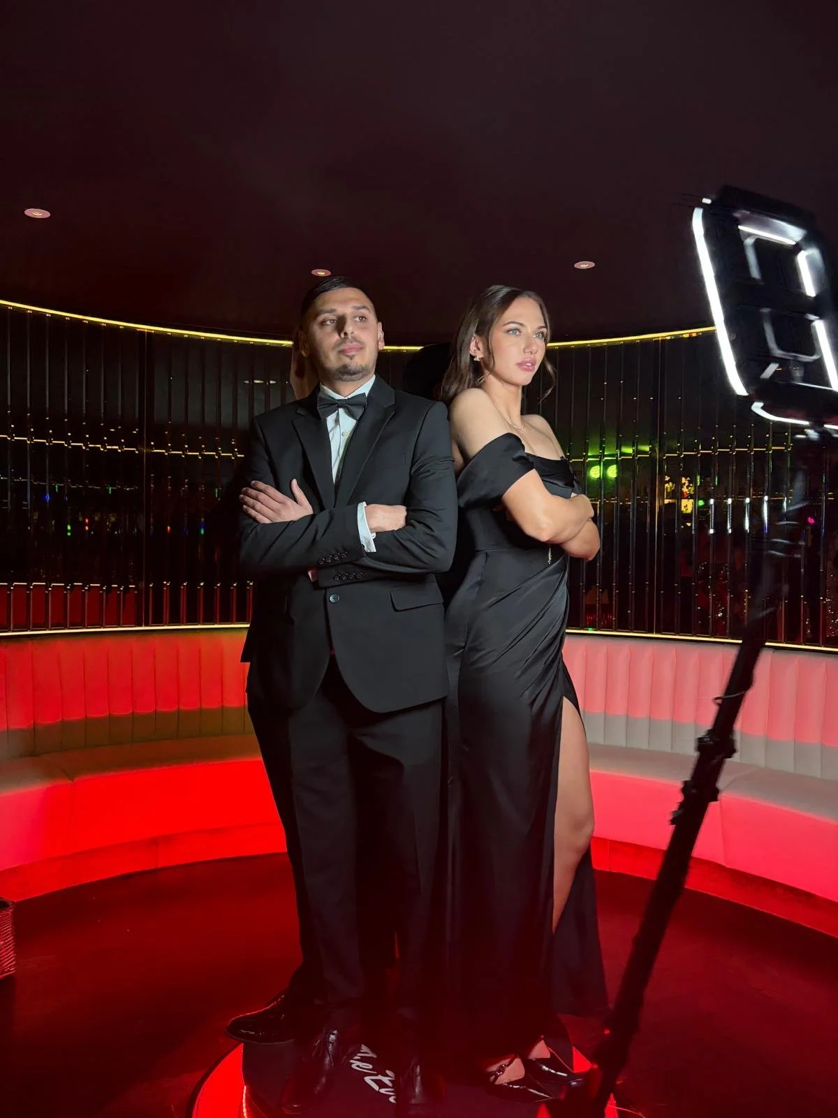 Two guests at a wedding pose in front of Mark the Event's Selfie Pod Camera. 
