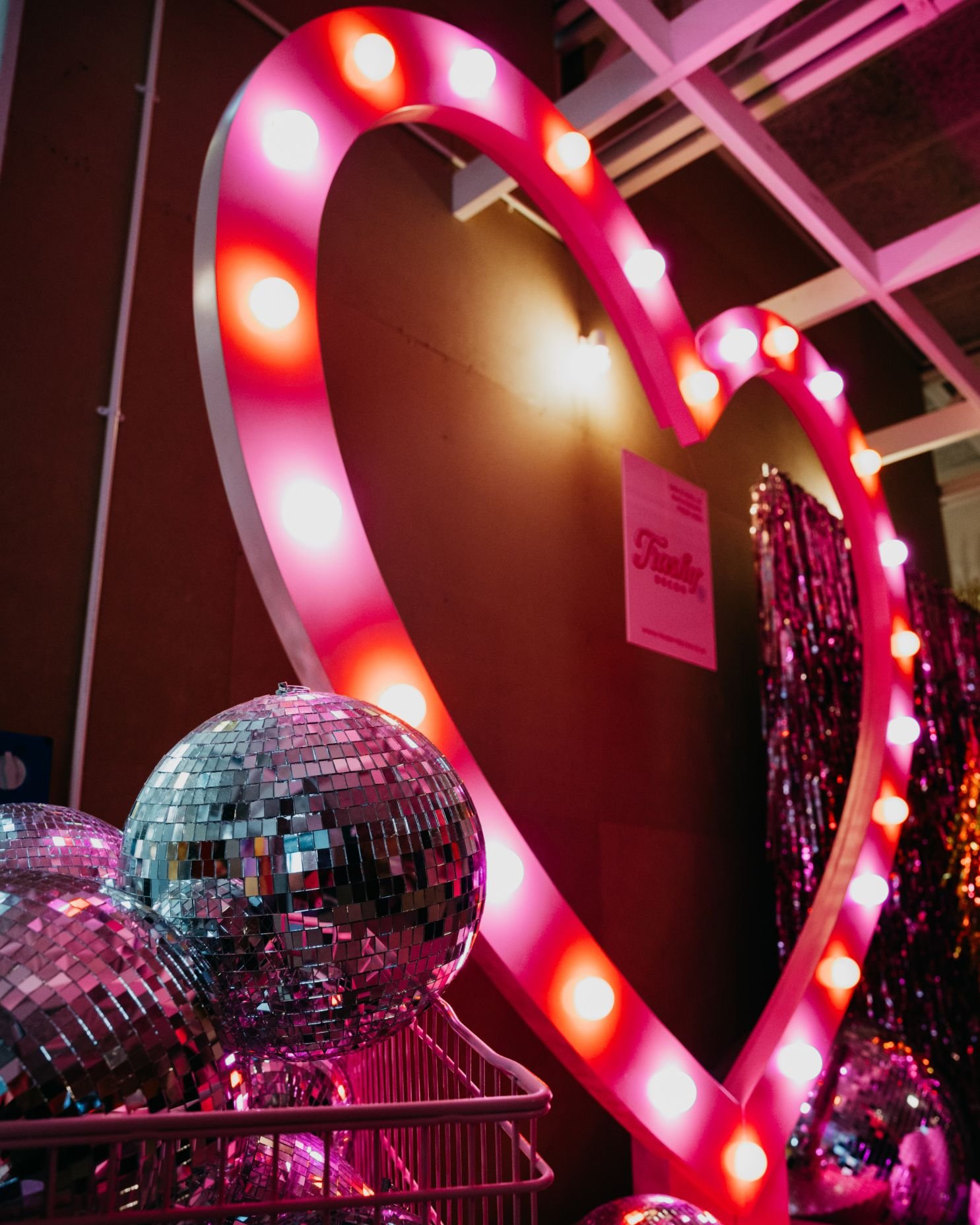 Pink neon Vegas Heart and a trolley full of disco balls at The Un-Wedding Show Liverpool.