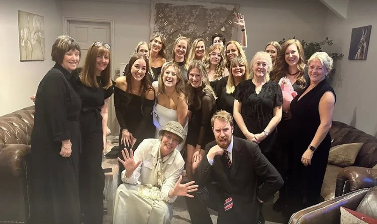 Moonstone Murders performers posing with wedding guests after an interactive murder mystery experience, creating fun and memorable entertainment.