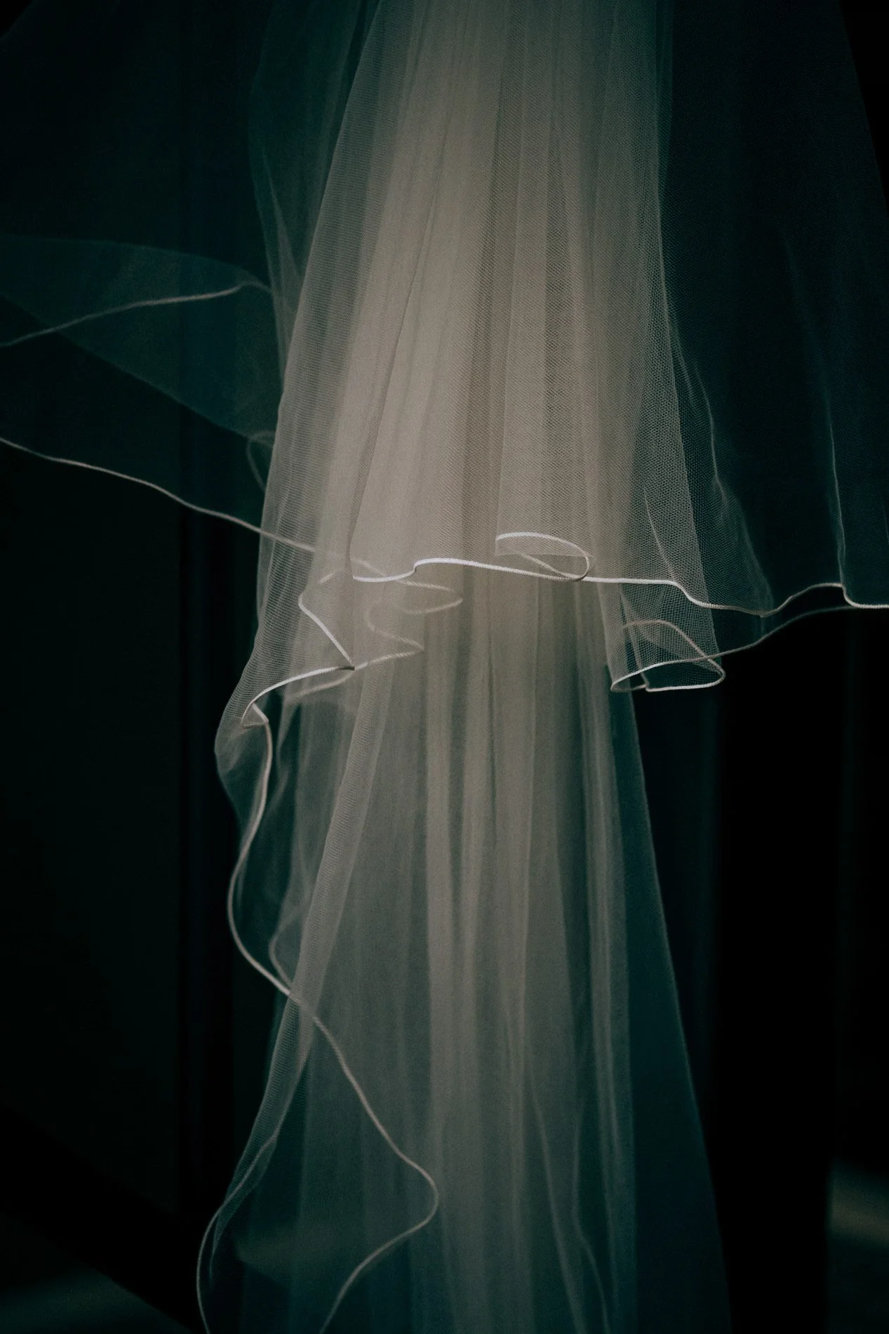 An ethereal close-up of a flowing bridal veil in soft light, capturing delicate textures and quiet elegance by Quiet Mornings Wedding Photography in Scotland.