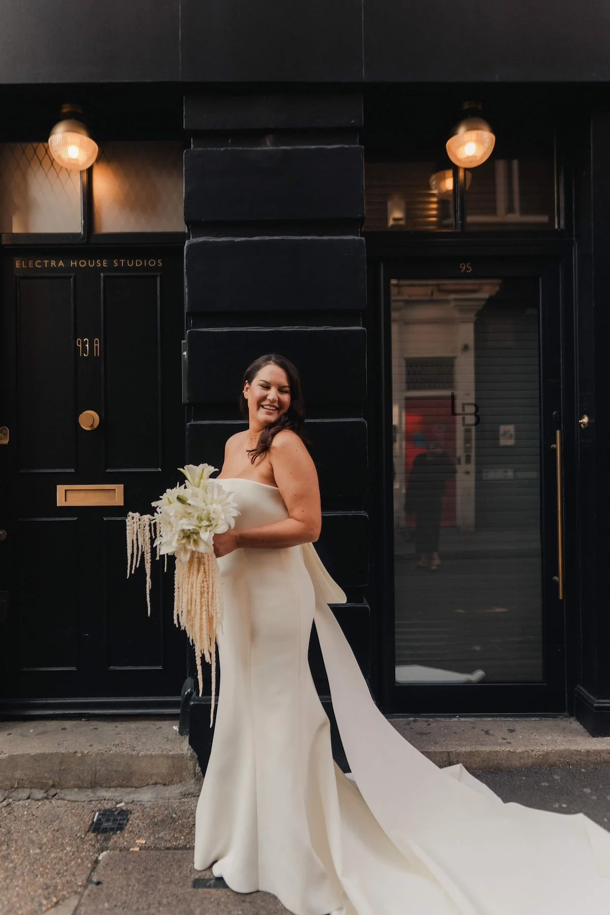 A bride is holding a unique bridal bouquet by Kitty Willow Flower Studio, Photo by The Chamberlains.
