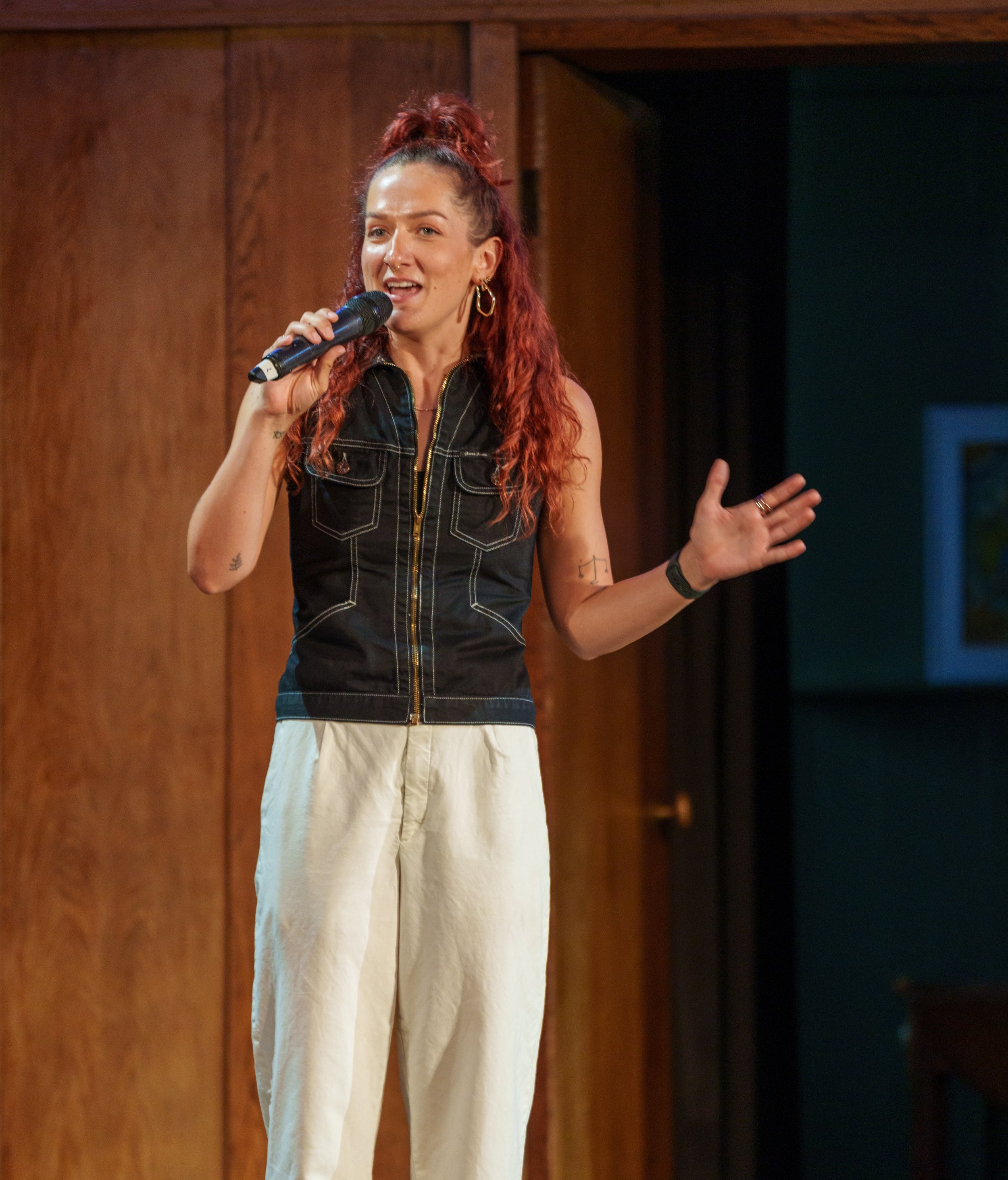 Robyn Smith Wedding Celebrant addressing a crowd, holding a microphone.