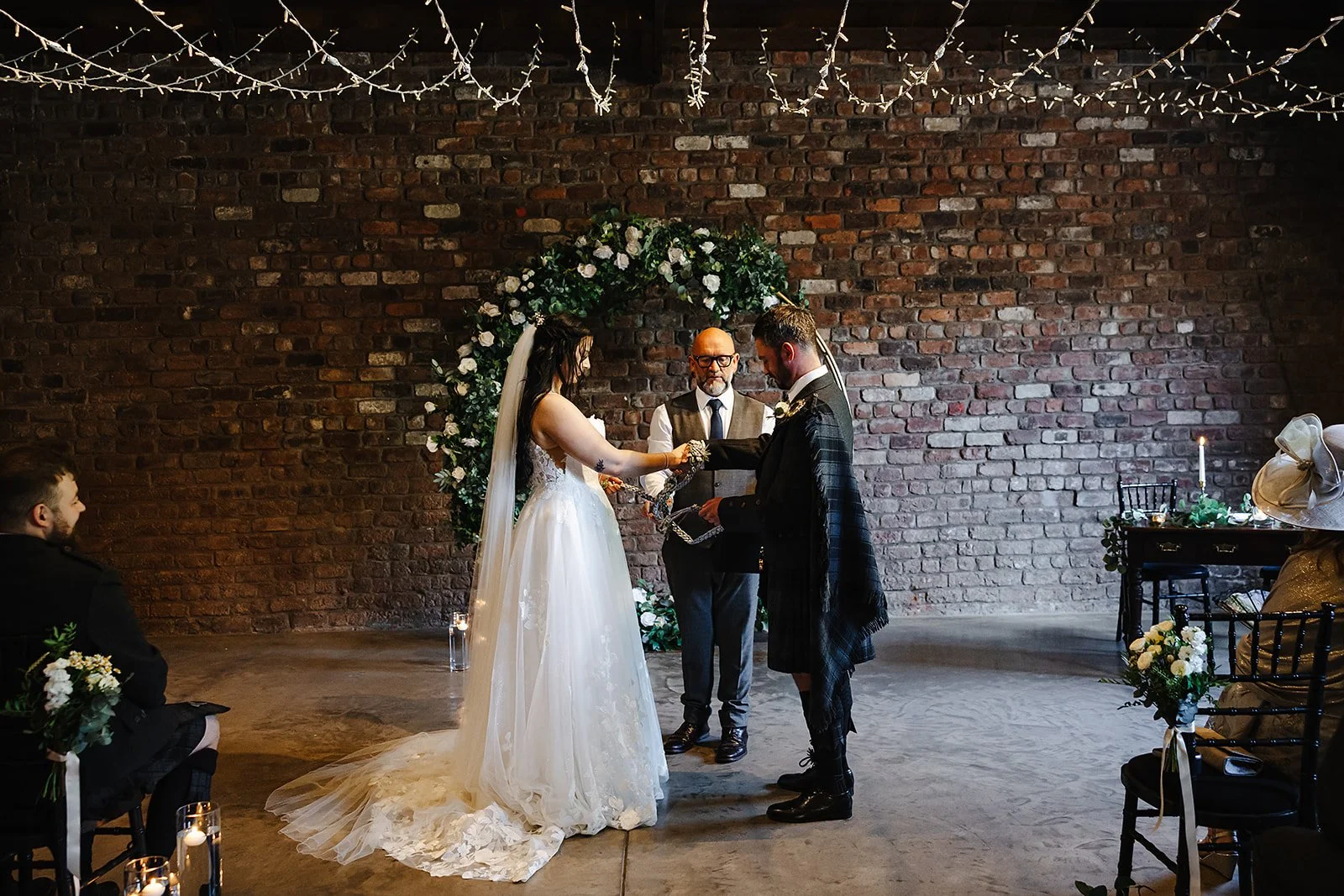The hand-fasting ceremony continues in front of the beautifully styled wedding altar at The Engine Works.