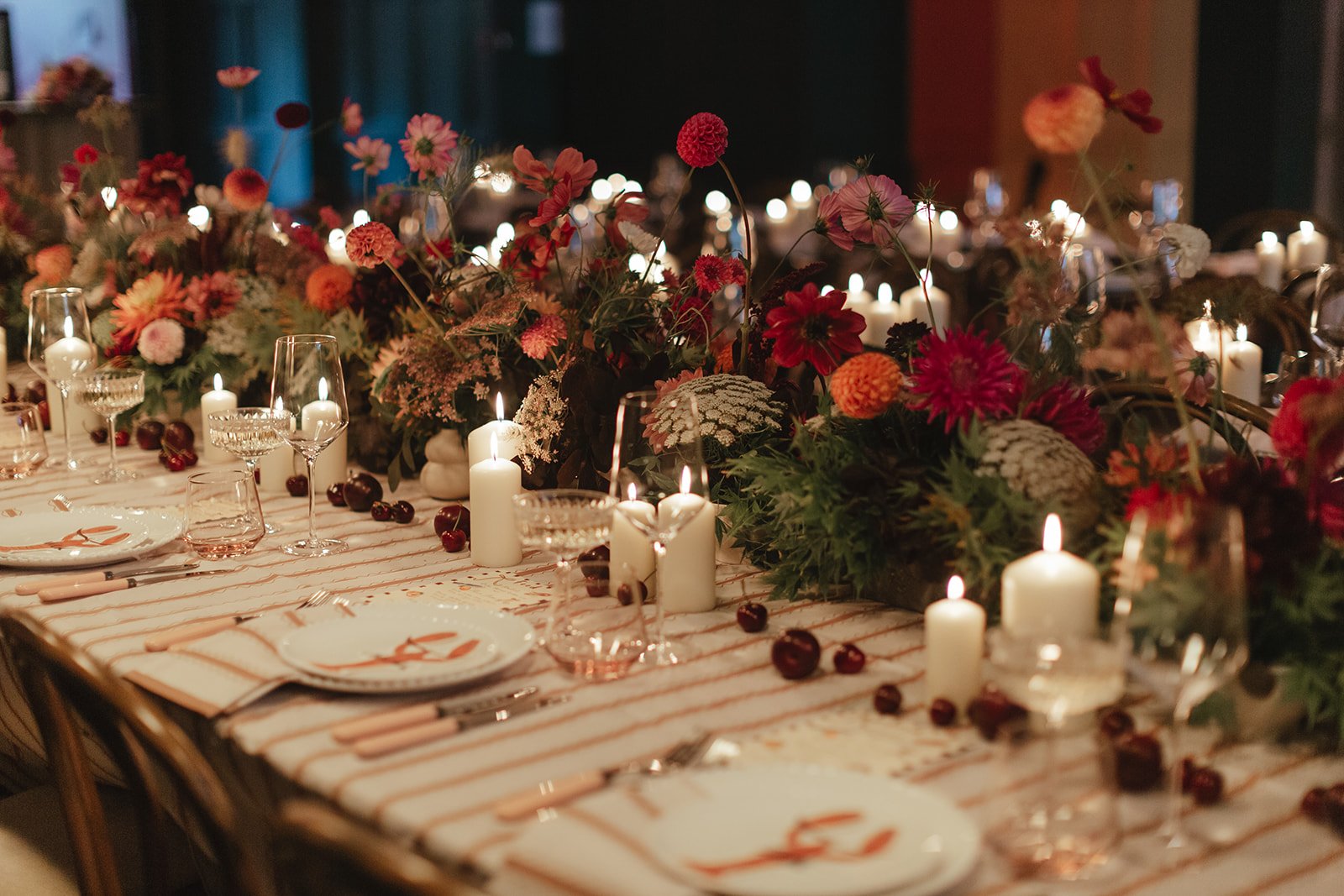 Candlelit tables styled with seasonal florals at Colours Wedding Venue in Shoreditch, highlighting an intimate, atmospheric London wedding reception.