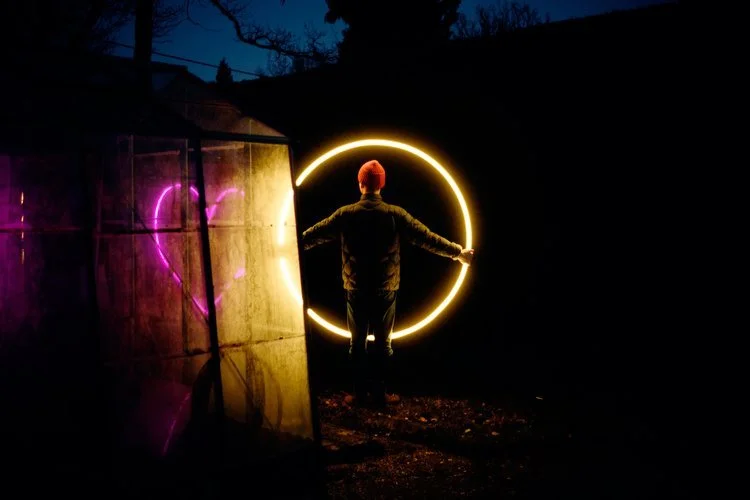 My Colour is Gold neon art installation featuring a glowing golden circle and pink heart, creating a dramatic and modern backdrop for weddings and events.