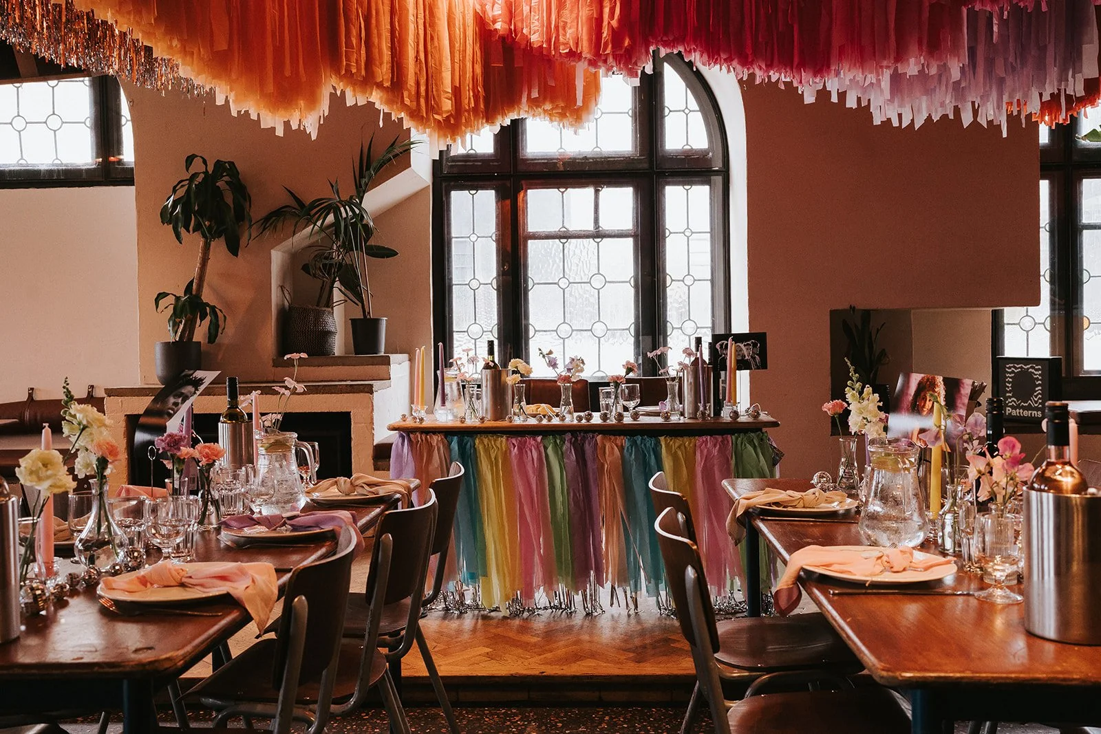 Colourful tables and creative décor inside Pier Court Wedding Venue in Brighton, showcasing a playful, modern seaside wedding reception space.
