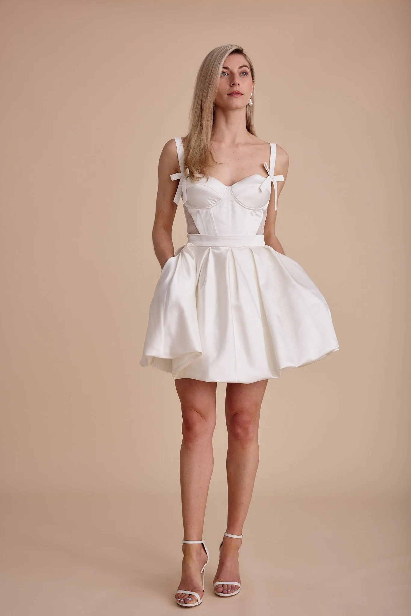 A cute mini wedding stress with a bralette top and straps by Swans Bridal