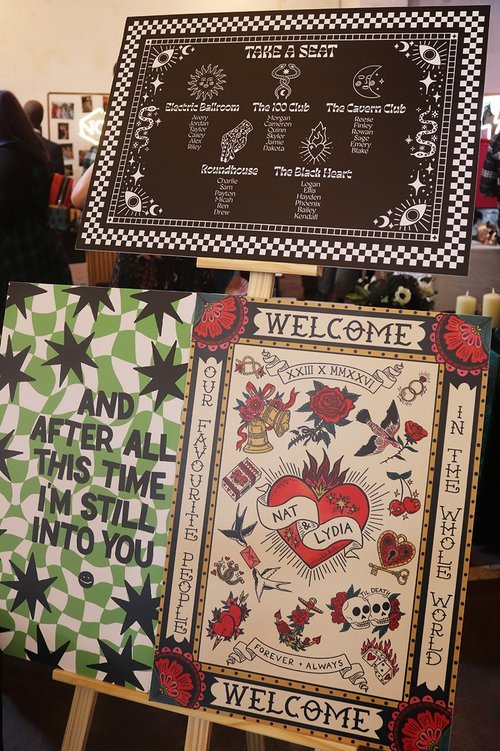 Bold and eclectic wedding signage by Different Day Design Studio, Dorset. Featuring rock ‘n’ roll–inspired seating plans and tattoo-style welcome boards, this creative display adds personality and edge - perfect for alternative couples planning a uni