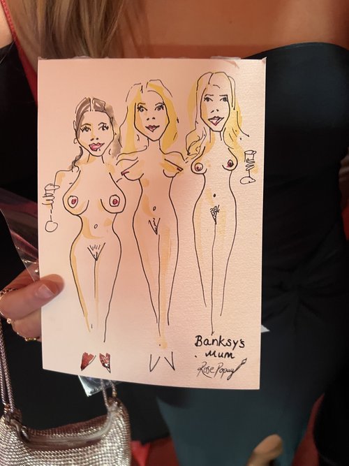 Rose Popay Event Artist creating cheeky and lighthearted caricature sketches of wedding guests, offering fun and memorable entertainment.