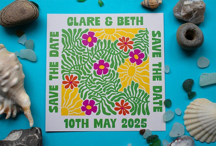Bright and playful “Save the Date” card by Different Day Design Studio, Dorset. Featuring bold green foliage, vibrant florals, and sunshine motifs, this colourful seaside-inspired design is perfect for couples planning a joyful, creative wedding cele