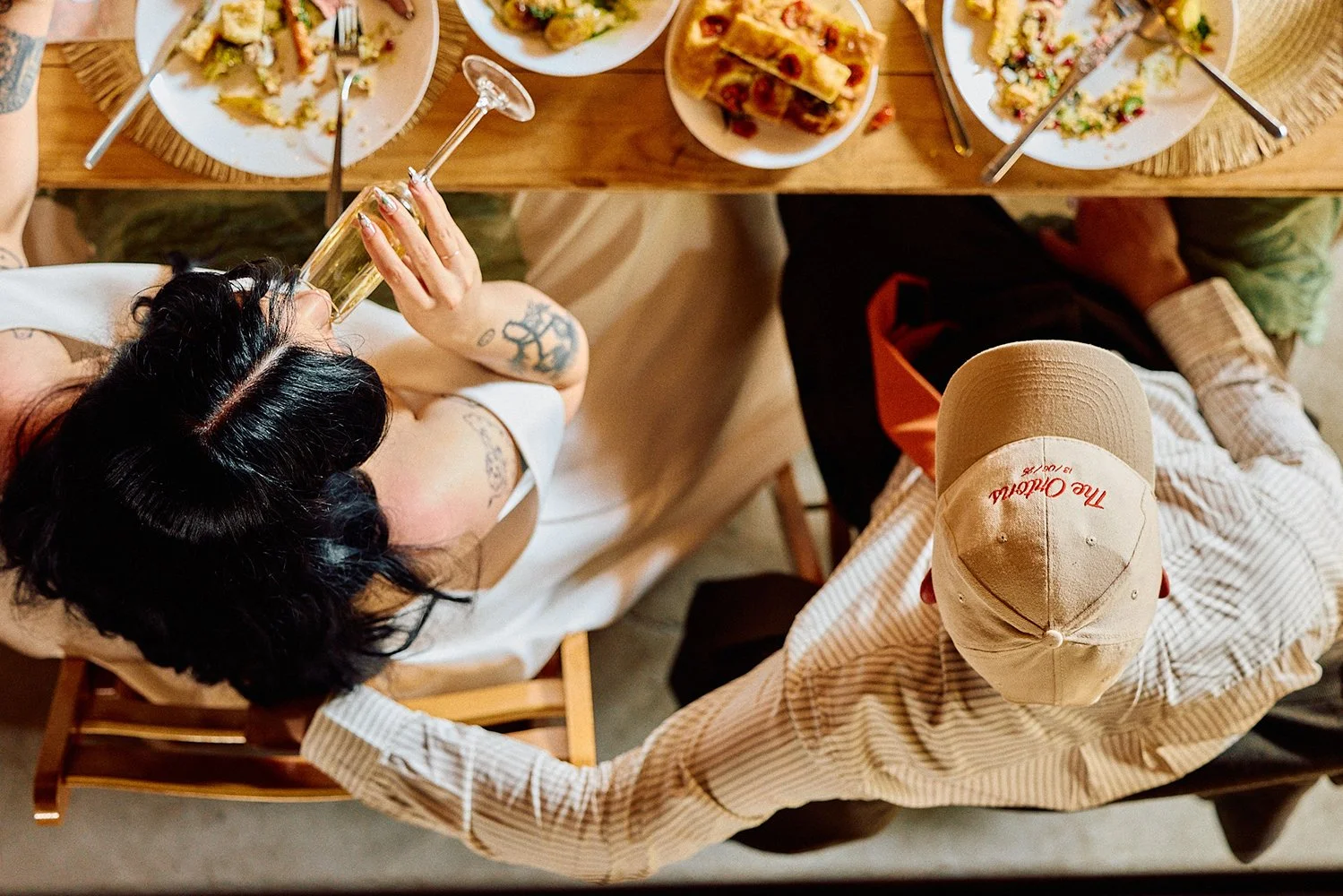 Elizabeth Royse Photography captures scenes with a raw documentary sensibility that blends playful spontaneity, cinematic framing and intimate close observation as seen in moments like a bride laughing her way down a stairwell beneath an ornate chand