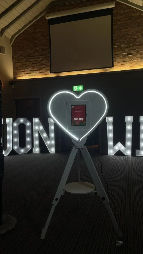 The heart-shaped photo booth from Mark the Event glows beautifully against the warm brick backdrop, creating a stunning focal point for evening celebrations. Perfect for weddings, parties, and corporate events, this elegant booth combines modern desi