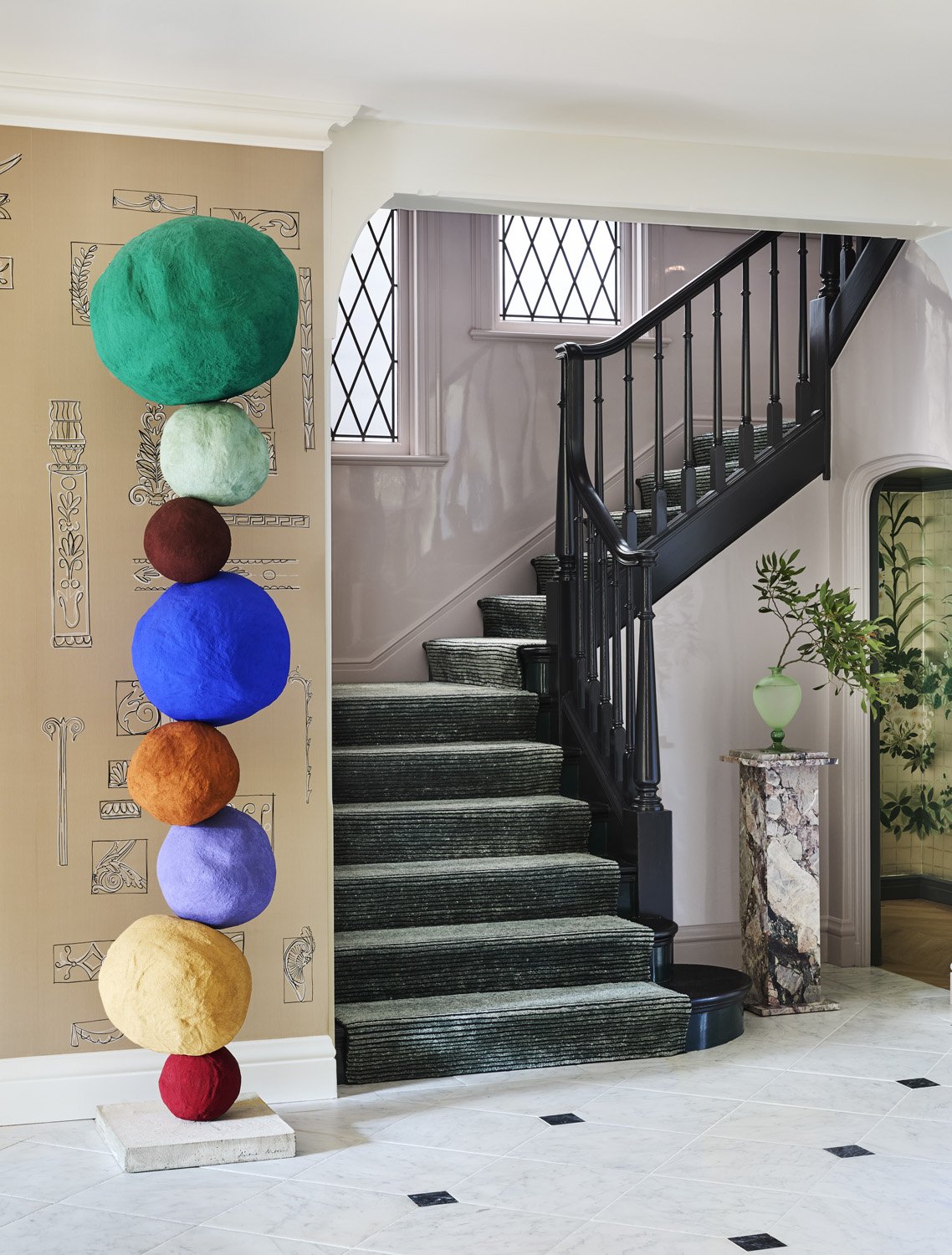 Entryway with staircase and Anne Morris sculpture in a San Francisco home designed by interior decorator Summer Thornton.