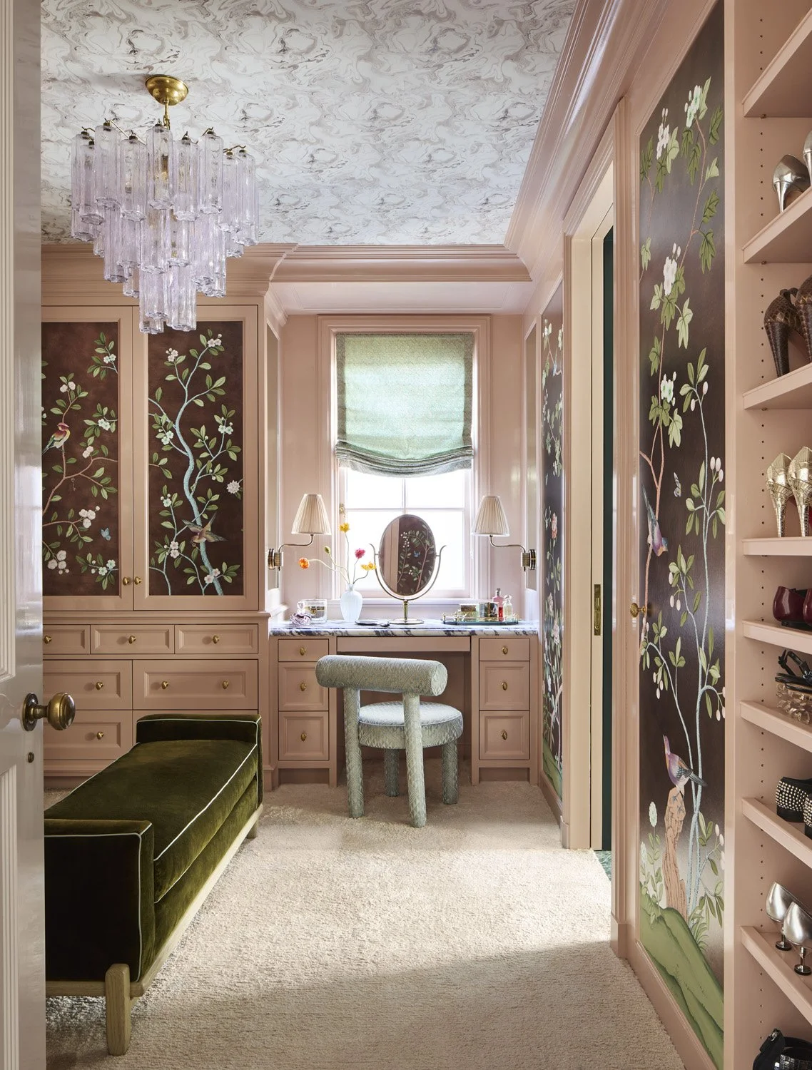 Feminine pink walk in closet with marbled ceiling and de Gournay wallpaper.