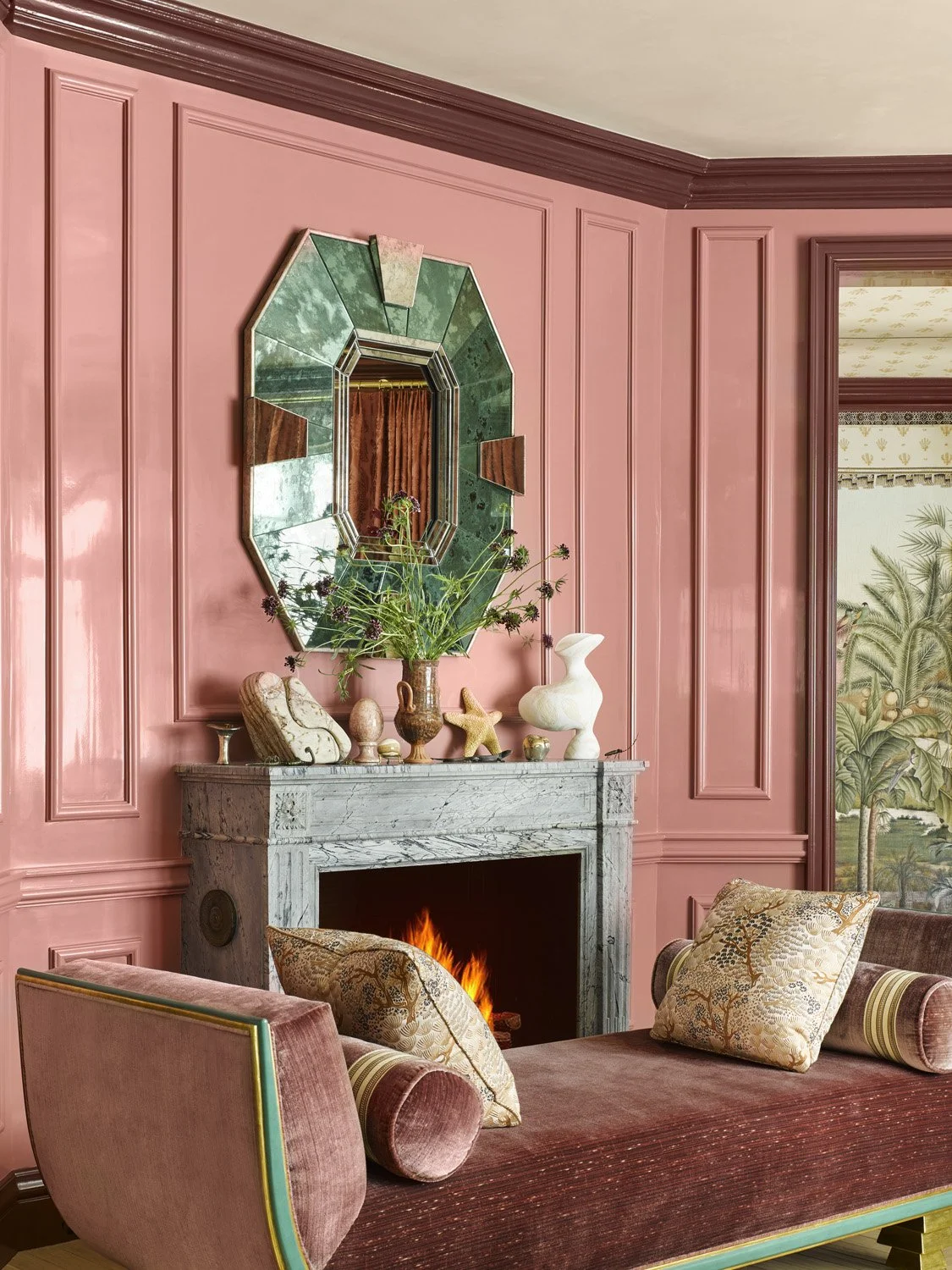 Fireplace in a San Francisco designed home by Summer Thornton featuring pink lacquered walls and a pink chaise lounge.