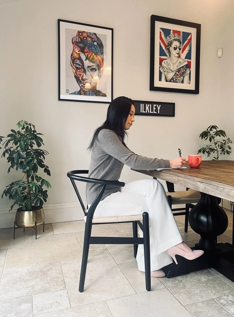 Li Lamb, hypnotherapist based in Ilkley, Yorkshire, writing in a cosy café, preparing personalised hypnotherapy and NLP sessions.