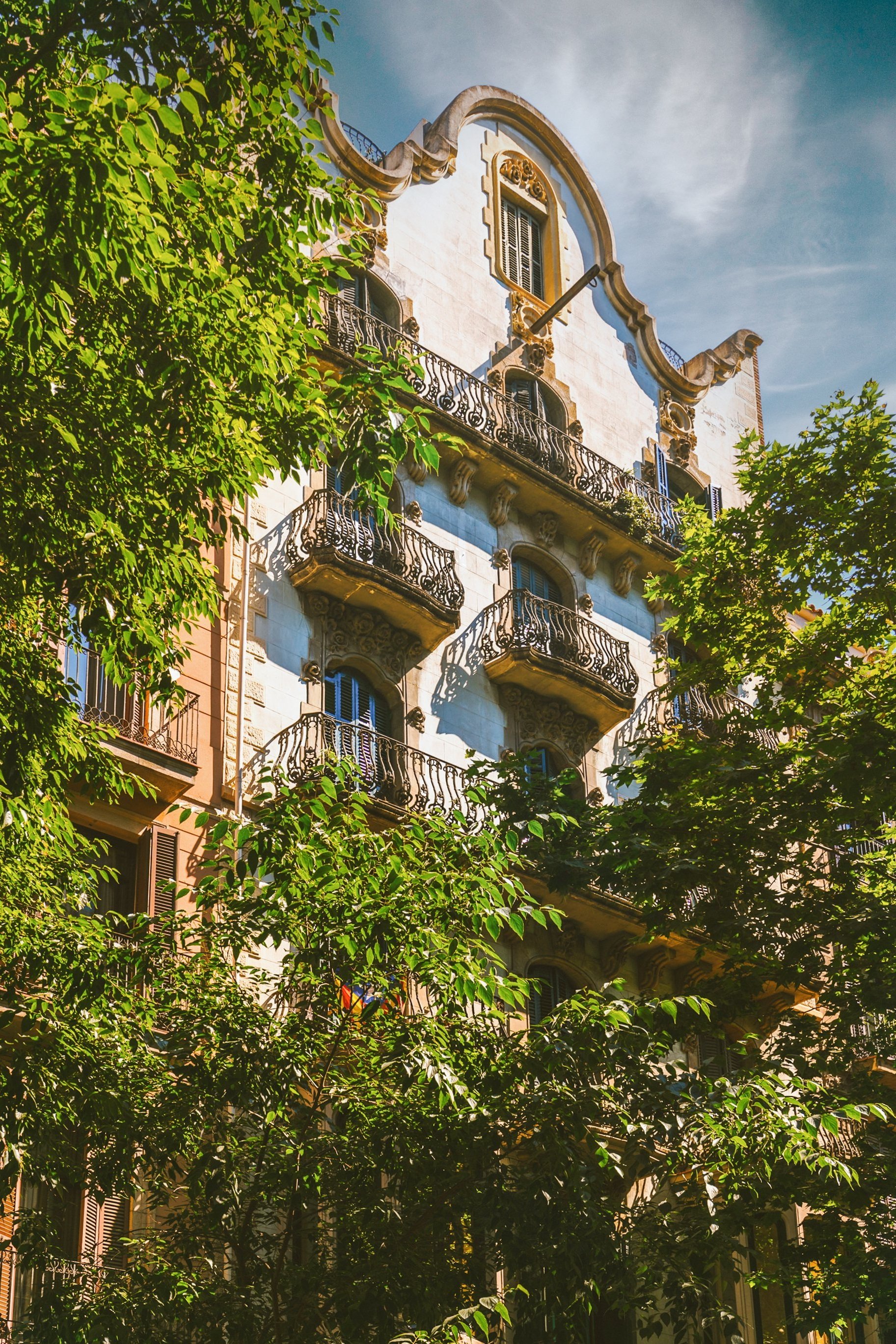 Historic modernist apartment building facade in Barcelona Eixample with wrought iron balconies