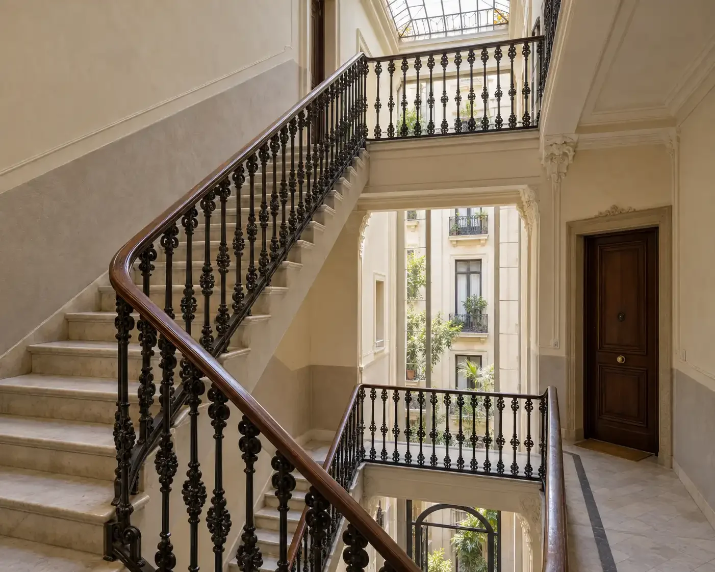 Historic Barcelona apartment building stairwell maintained for international property owners.