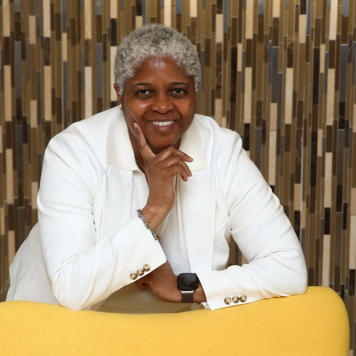 Liz Smith, smiling, in a white blazer