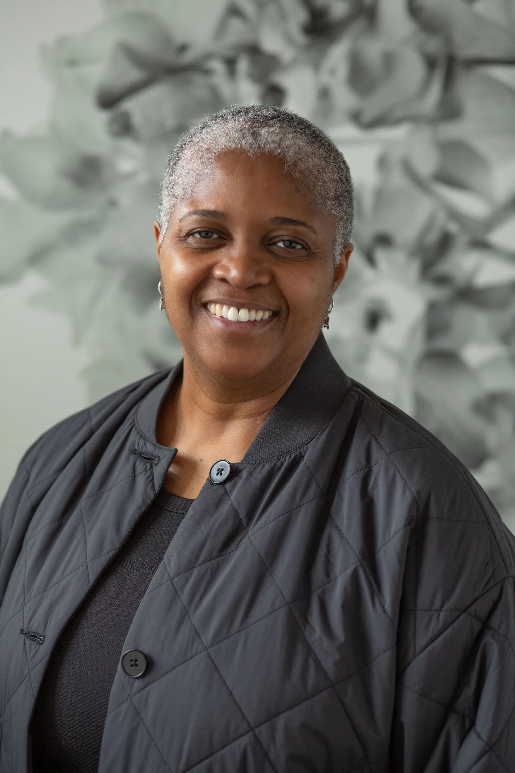 Liz Smith, licensed paralegal, smiling, in a dark quilted jacket