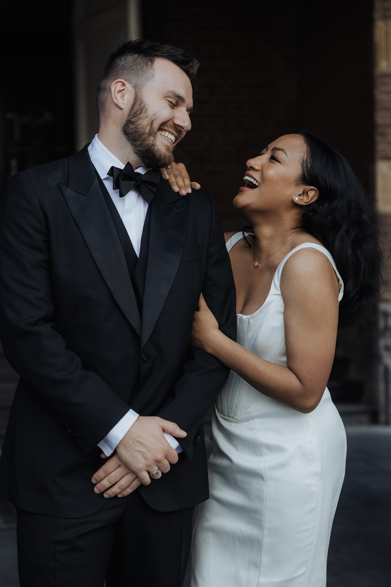 Multicultural wedding couple sharing a joyful moment in Hoorn, the Netherlands.