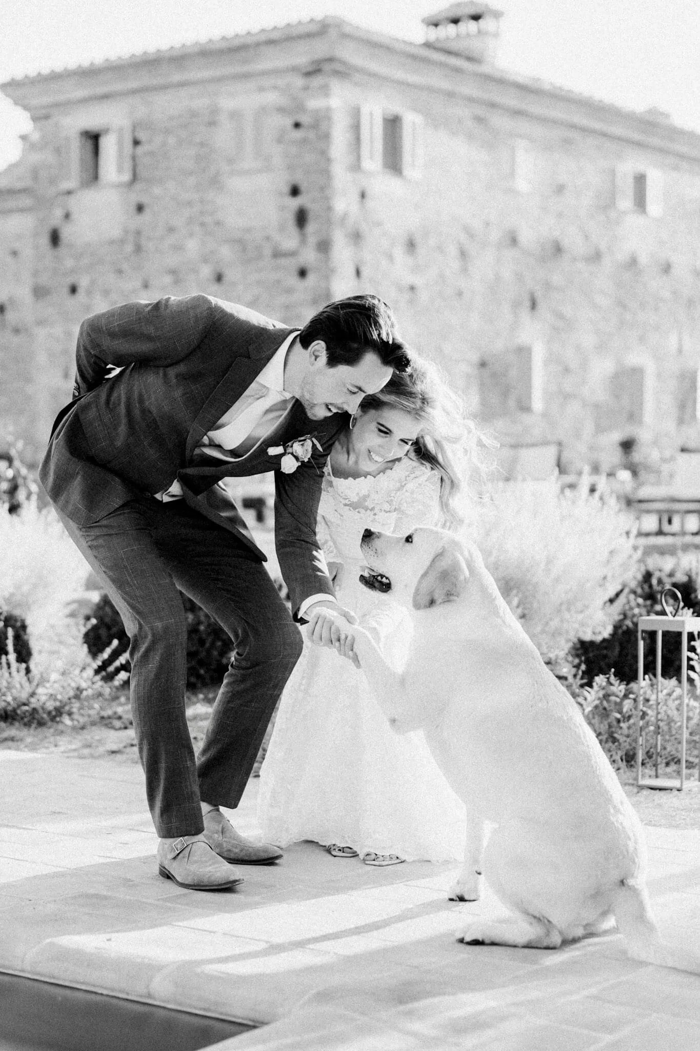 bride and groom sharing joyful moment with dog destination wedding Assisi