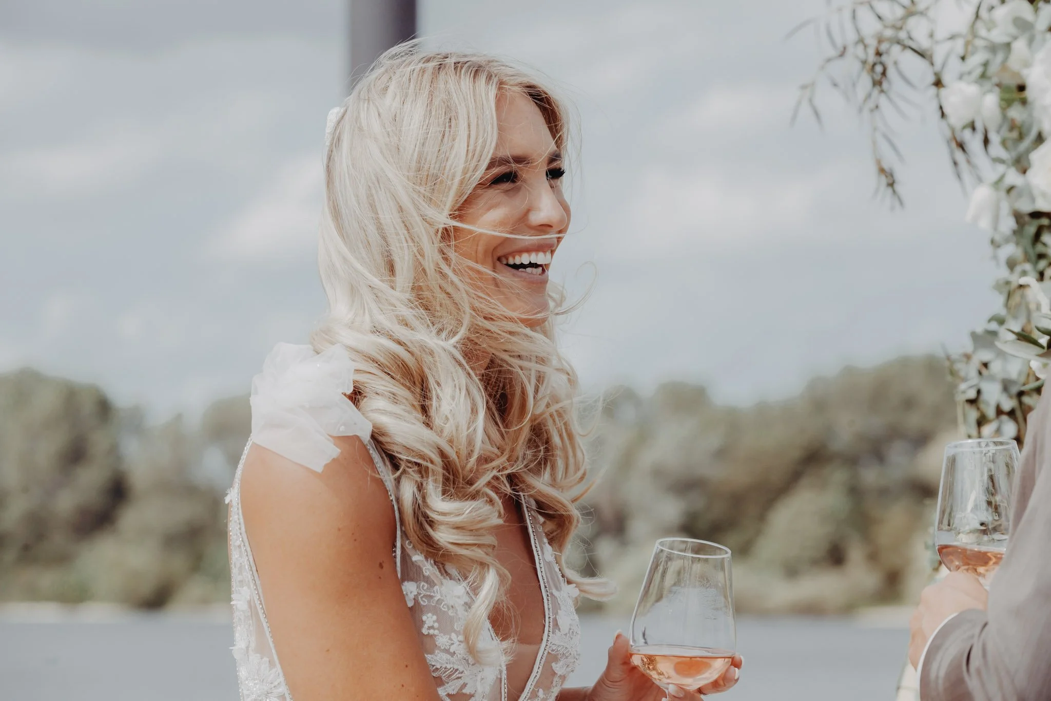 Windblown bridal moment captured at a luxury destination wedding in Kerkdriel.