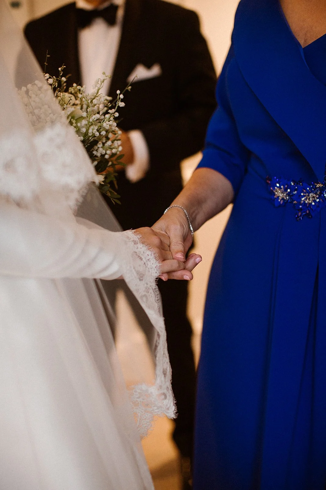 Winter bride holding her mother’s hand before the ceremony at Waldorf Astoria Amsterdam.