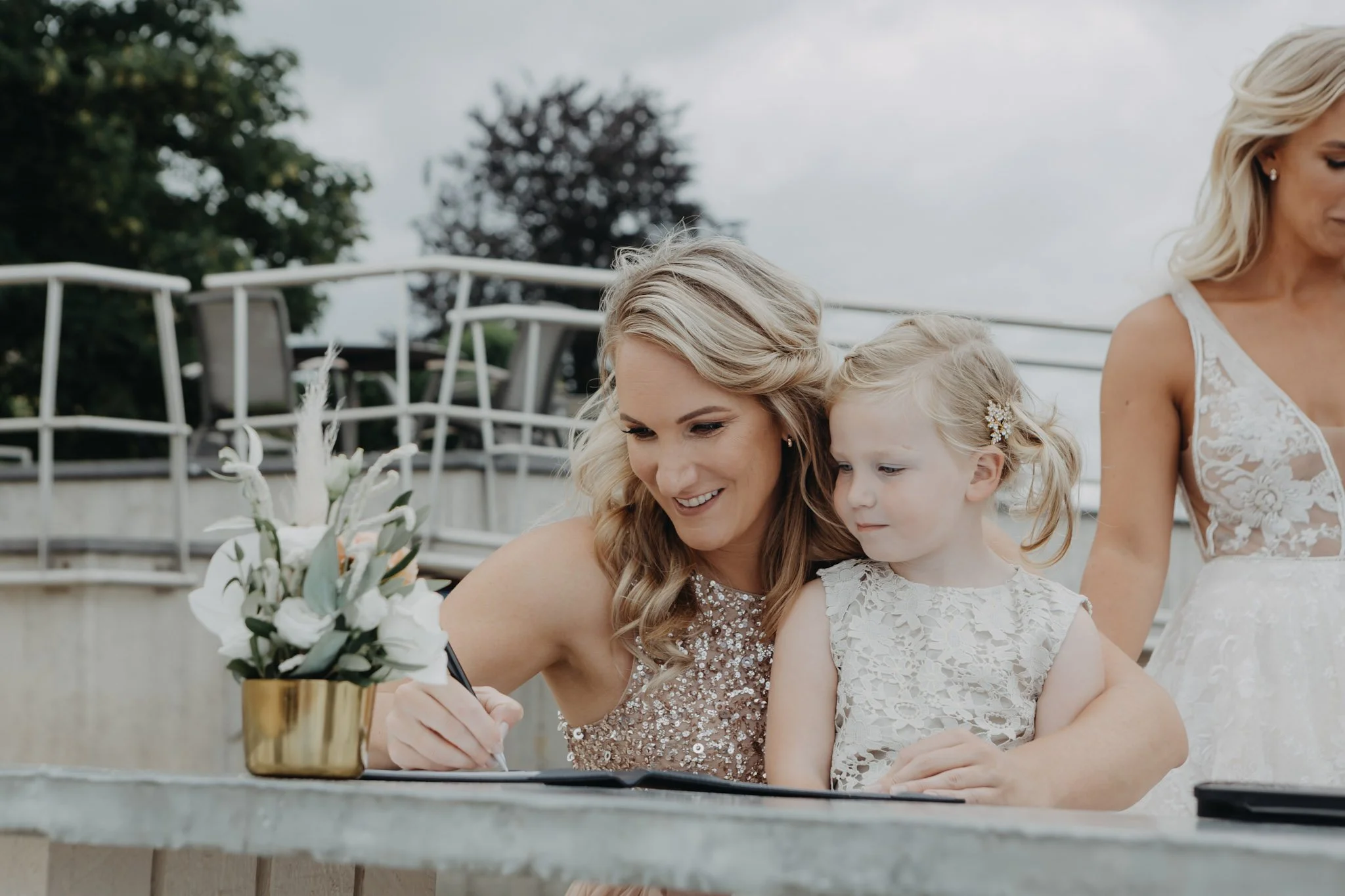 Maid of honour signing official documents during a luxury wedding in Kerkdriel, Netherlands.