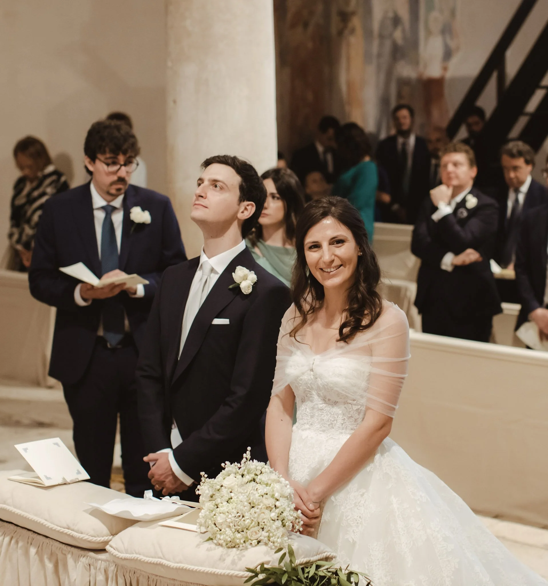 Emotional church wedding moment in Italy, with the bride styled by luxury bridal glam artist.
